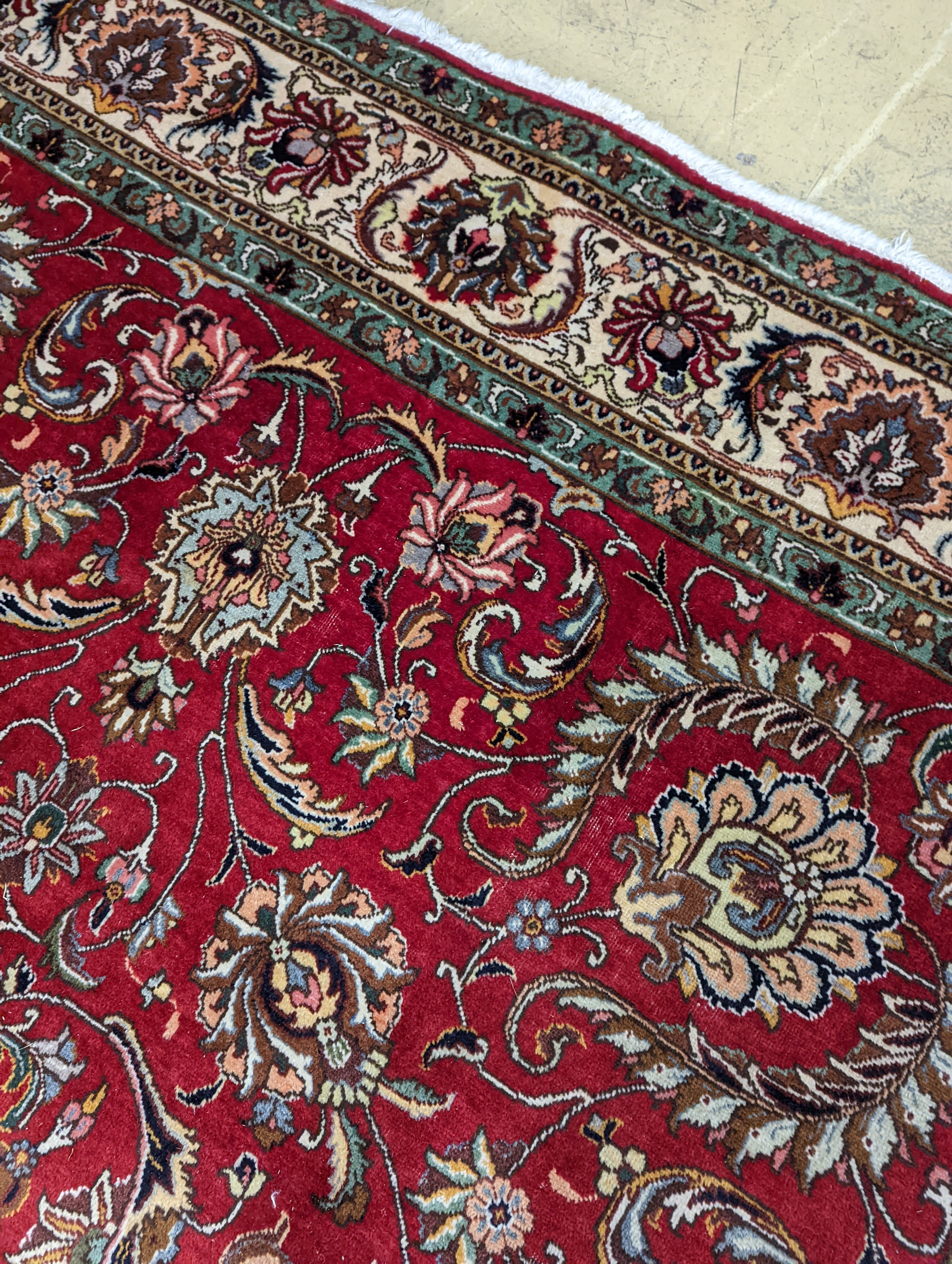 A Tabriz red ground carpet, 400 x 290cm